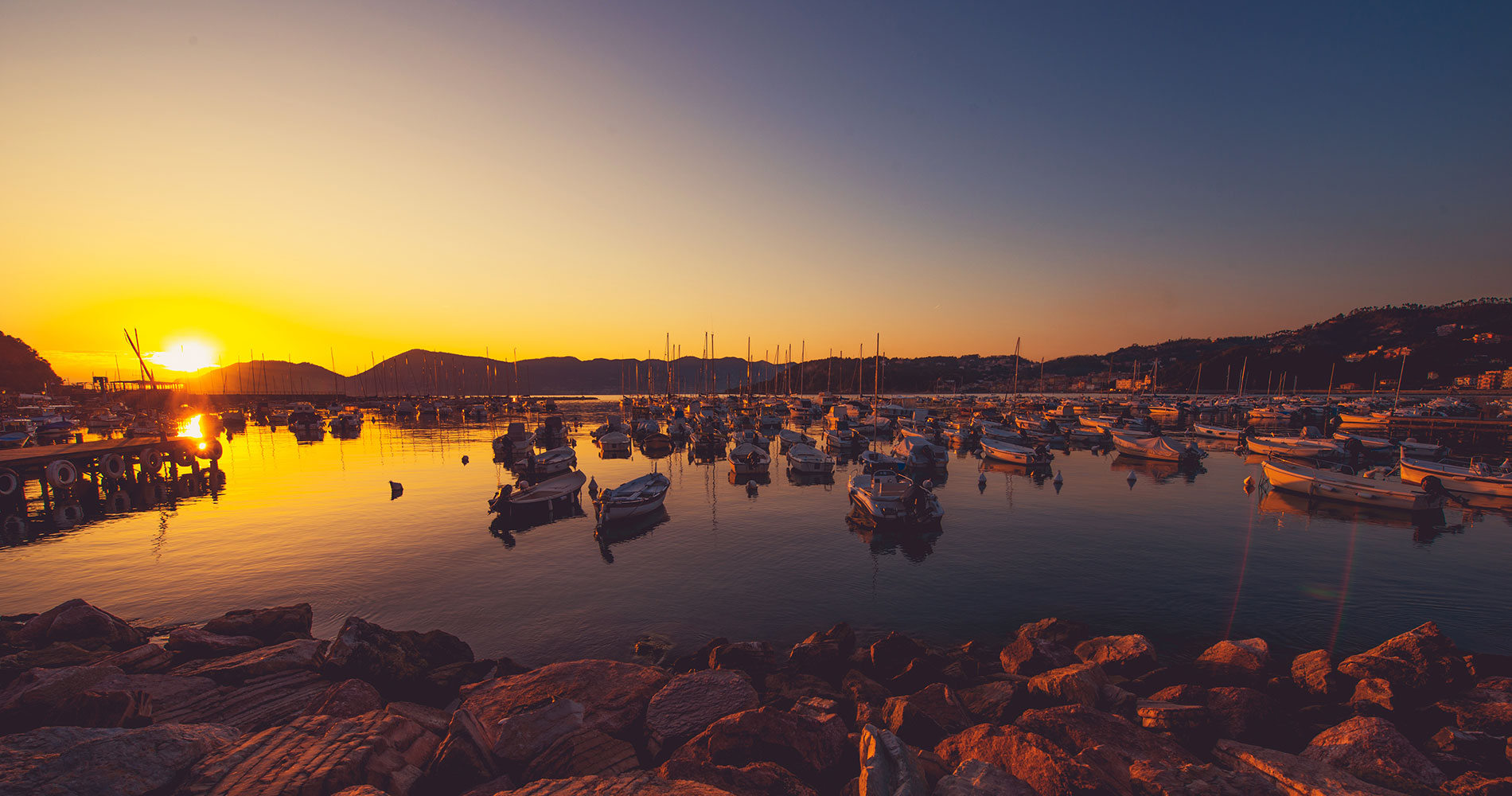 Sunset photo of the boats moored at the small port of Lerici